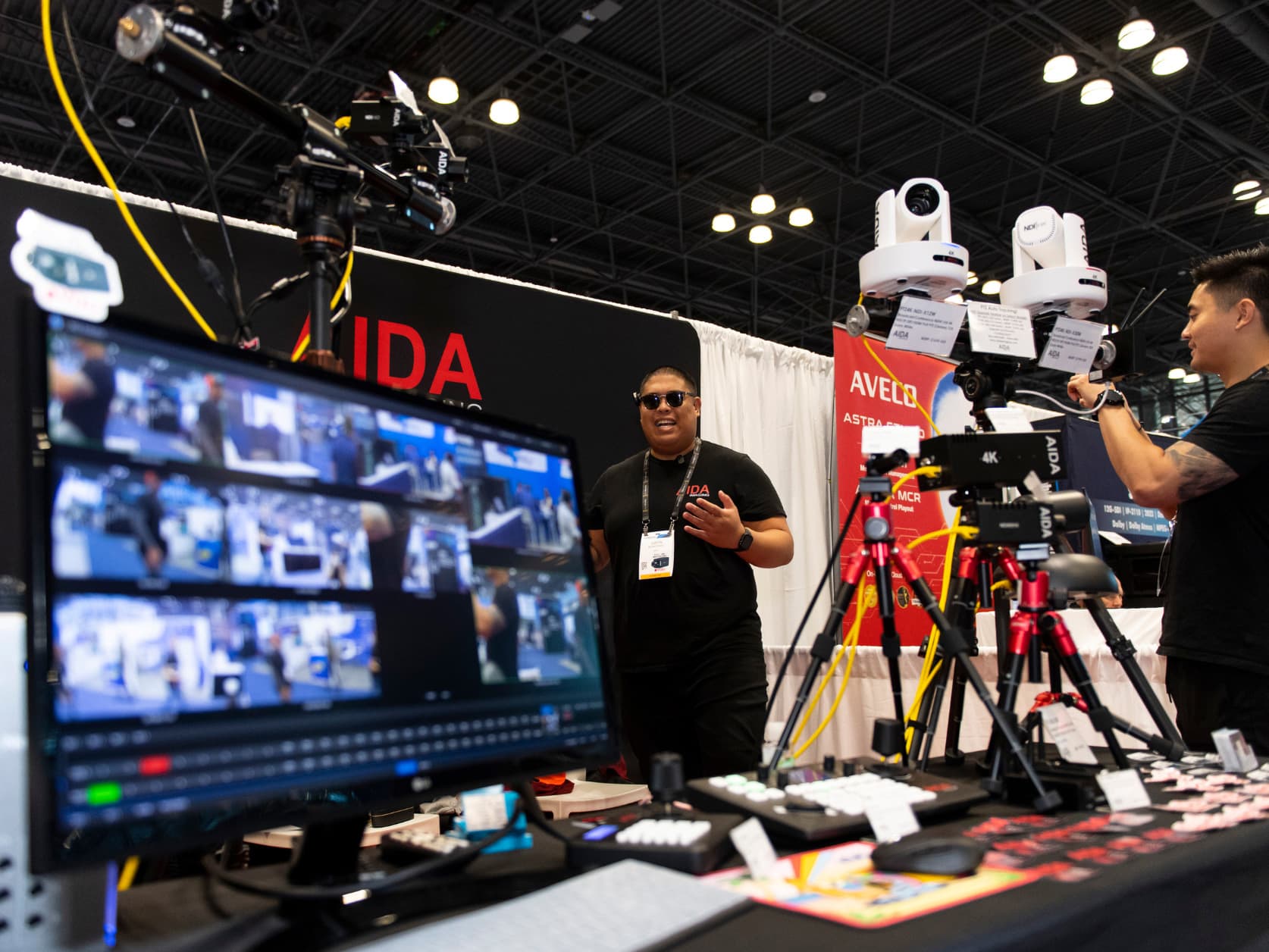 An exhibitor is displaying their products and technology at their booth on the show floor.
