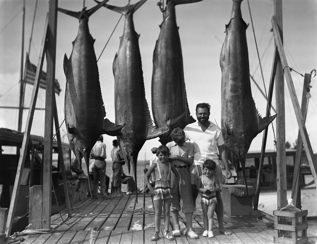 Ernest Hemingway and his three sons with a blue marlin on the docks of Bimini. July 20, 1935. Cr: Ernest Hemingway Collection. John F. Kennedy Presidential Library and Museum, Boston