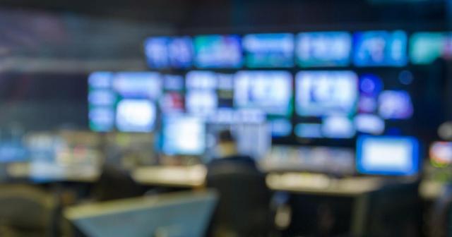 Blurry image of broadcast newsroom