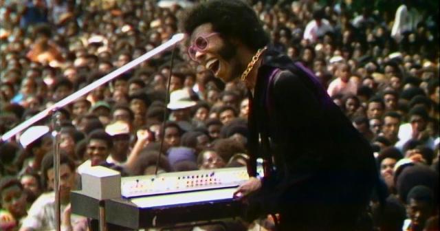 Sly Stone performs at the Harlem Cultural Festival in 1969, featured in the documentary “Summer Of Soul (Or, When The Revolution Could Not Be Televised).” Cr: Mass Distraction Media/Searchlight Pictures