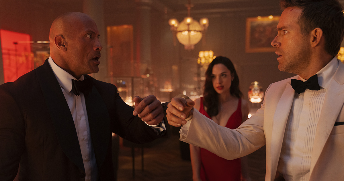 Dwayne Johnson is the FBI’s top profiler John Hartley, Gal Gadot is the world’s most wanted art thief “The Bishop” and Ryan Reynolds is the world’s greatest art thief Nolan Booth in Netflix's RED NOTICE. Directed and written by Rawson Marshall Thurber,  Cr: Frank Masi / Netflix © 2021