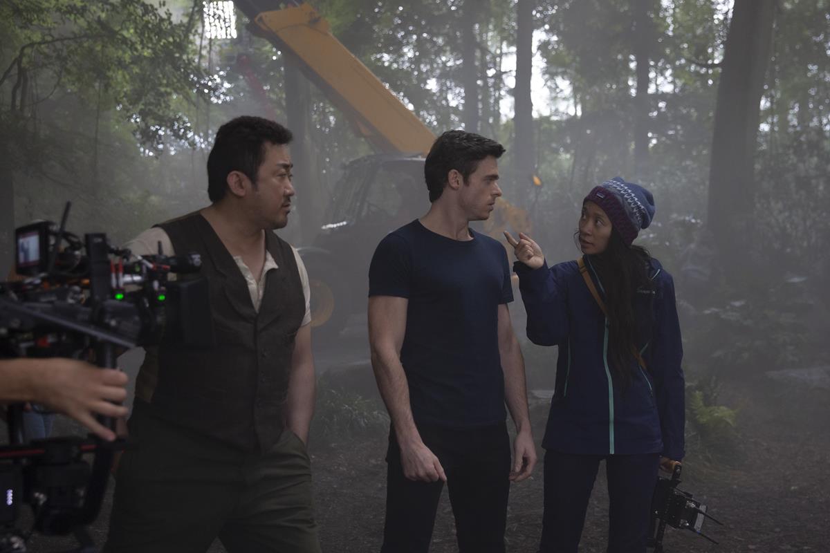 Don Lee, Richard Madden, and director Chloé Zhao on the set of “Eternals.” Cr: Marvel Studios