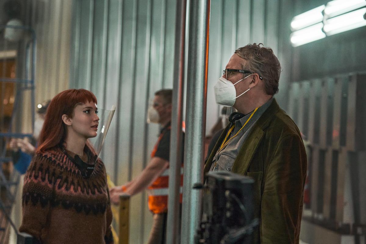 Jennifer Lawrence and director Adam McKay on the set of “Don’t Look Up.” Cr: Niko Tavernise/Netflix
