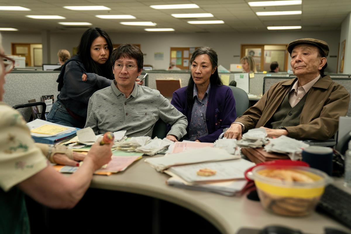 Stephanie Hsu as Joy Wang, Ke Huy Quan as Waymond Wang, Michelle Yeoh as Evelyn Wang, and James Hong as Gong Wang in “Everything Everywhere All At Once,” directed by Daniel Kwan and Daniel Scheinert. Cr: Allyson Riggs/A24