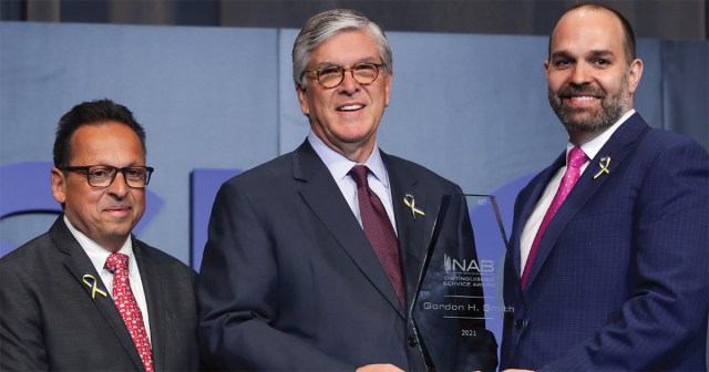 Former President and CEO Gordon Smith (center), receives the NAB Distinguished Service Award from Curtis LeGeyt (right), NAB President and CEO, and David Santrella, CEO, Salem Media Group and NAB Joint Board Chair.