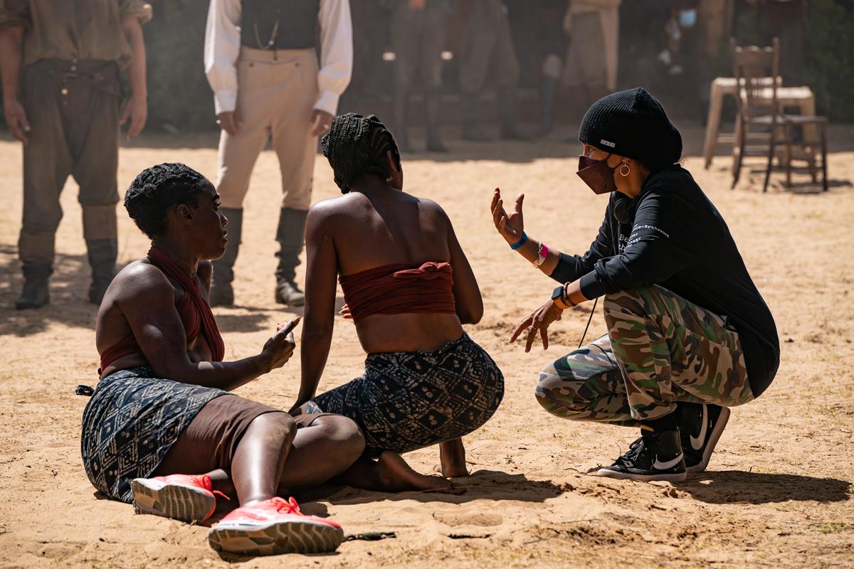 Director Gina Prince-Bythewood, Lashana Lynch, and Thuso Mbedu on the set of “The Woman King.” Cr: Ilze Kitshoff/Sony