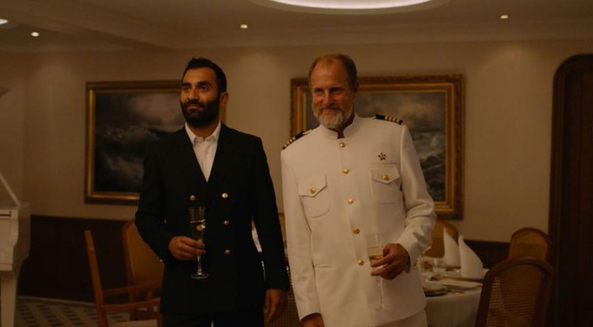 Arvin Kananian as Darius and Woody Harrelson as The Captain in director Ruben Östlund’s “Triangle of Sadness.” Cr: NEON