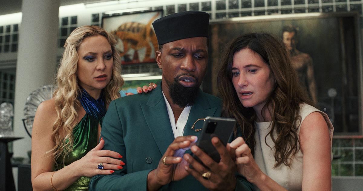 Kate Hudson as Birdie Jay, Leslie Odom Jr. as Lionel Toussaint, and Kathryn Hahn as Claire Debella in writer/director Rian Johnson’s “Glass Onion: A Knives Out Mystery.” Cr: Netflix