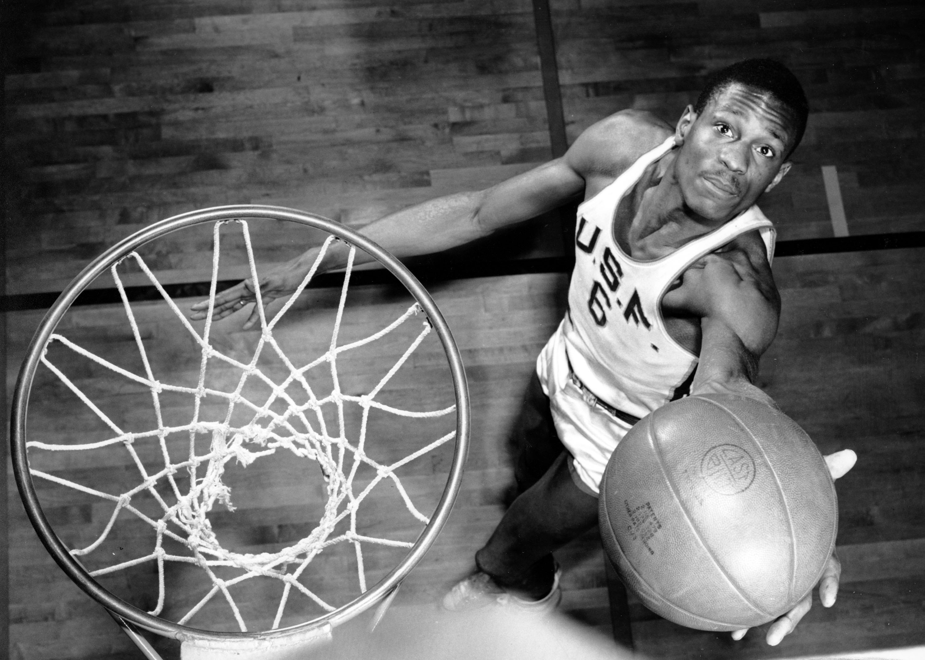 Bill Russell, member of the University of San Francisco basketball team, shows how he scores baskets on Feb. 23, 1956. The 6-foot, 10-inch center, ranked one of the best, has helped his team win 20 straight games during the current season. cr: AP Images/Courtesy of Netflix
